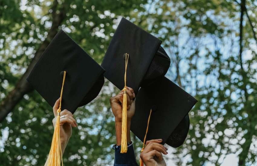 A Group of People Holding Graduation Caps.